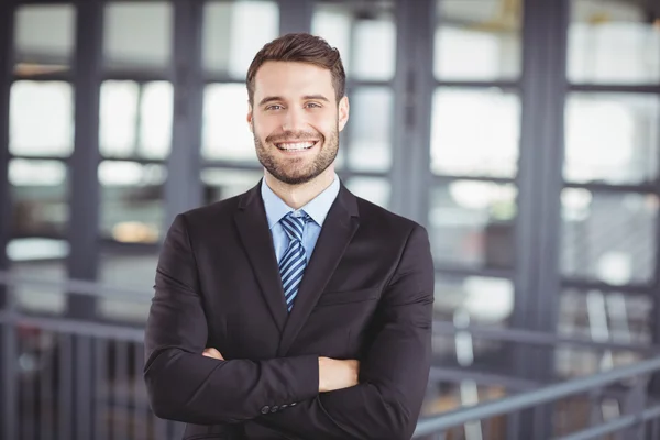 a man in a suit with his arms crossed
